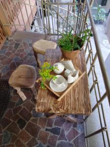 aamboo table with plates and bowls and plants on it at Boutique Fantasy in Tbilisi City