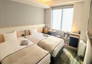 Voodi või voodid majutusasutuse Urban Hotel Kyoto Gojo Premium toas