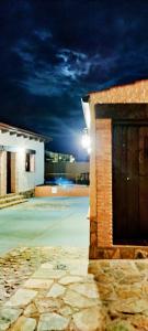 a night view of a building with a garage at Los Montes in Casas de Miravete