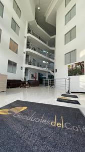 an empty lobby of a building with a carpet at Apartahotel cerca Parque del Café, 506A in Montenegro