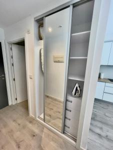 a large mirror in a room with a closet at Holiday studio apartment near the beach and city centre in Gibraltar