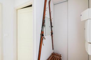 a pair of skis hanging on a wall next to a door at Chalet de Peyrelance in Cauterets