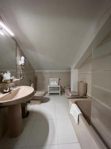 a bathroom with two toilets and a sink at Hotel Regueiro in Tox +54 photos