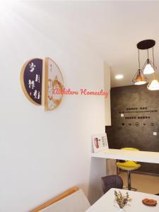 a room with a table and a clock on the wall at Aishiteru Homestay in Kuala Lumpur