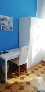 a white desk and a white chair in a room at Ahm7nani in Mascali