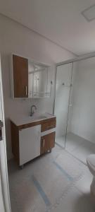 a bathroom with a sink and a toilet in it at Apartamento Ponta do Papagaio - Térreo in Palhoça