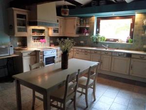 a kitchen with a table and chairs and a window at Le Relais du Malpas in Namur +19 photos