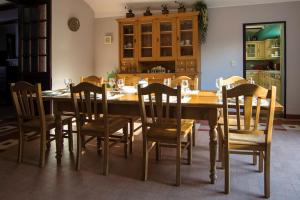 a dining room with a wooden table and chairs at Le Relais du Malpas in Namur +40 photos