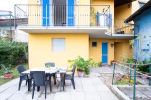 a patio with a table and chairs in front of a building at B&B Tra Lago e Stelle in Cissano