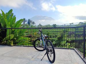 a bike parked in front of a fence at Jero Tumbuk Private Villa in Selat