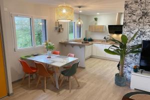 a kitchen and dining room with a table and chairs at Latitude Savoie in Drumettaz-Clarafond