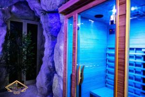 a room with a rock wall next to a door at Napoli Centro Suite e Spa in Naples +43 photos