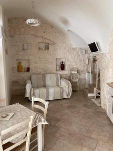 una sala de estar con un sofá y una mesa en Il Giardino del Borgo, en Cisternino