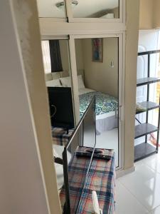 a small room with a bed and a mirror at Lucerna 3 in La Cana