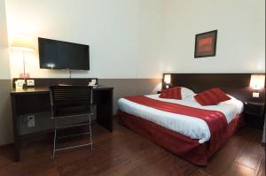 a hotel room with a bed and a desk with a television at Appart'City Classic Lyon Part-Dieu in Lyon +26 photos