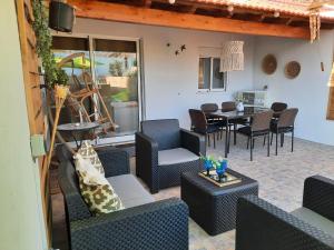 a patio with couches and a table and chairs at A CASA DA VILA in Ermidas