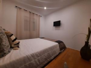 Un pat sau paturi într-o cameră la A CASA DA VILA
