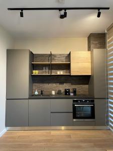 a kitchen with stainless steel appliances and wooden cabinets at Buena Vista Villas in Varna City +34 photos