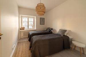 a bedroom with two beds and a window at ULEABO New, Light and Roomy 61m² Apartment With Sauna! in Oulu