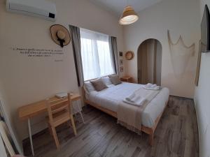 a bedroom with a large bed and a window at ARCO VESUVIANO in Madonna dellʼArco