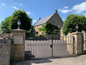 an iron gate in front of a house at The Cottage at Well House in Shepton Mallet