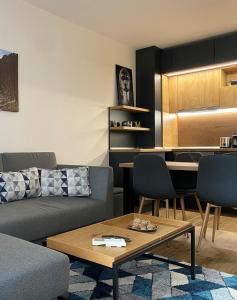 a living room with a couch and a table at Arletti Luxury Apartment in Ruse