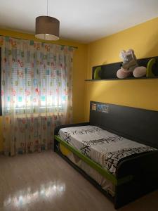 a small bedroom with a bed and a curtain at Las Moreras in Calatayud