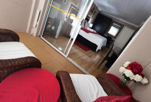 a view of a hotel room with two beds and a mirror at Blyde Lodge in Graskop