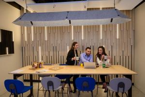 a group of people sitting around a table at ibis Styles Paris Opera Lafayette in Paris