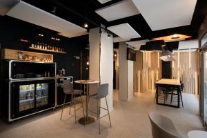 a room with a bar with chairs and a table at ibis Styles Paris Opera Lafayette in Paris
