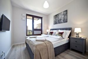 Posteľ alebo postele v izbe v ubytovaní Marina Mokotow P&O Serviced Apartments