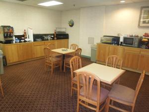 una sala de espera con mesas, sillas y un mostrador en Pottsville Inn, en Pottsville