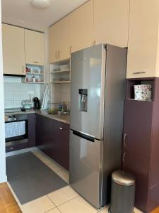 a kitchen with a large stainless steel refrigerator at City Break Arena Zagreb in Zagreb