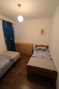 a bedroom with two beds and a lamp at Villa Lujko in Prapatnica +109 photos