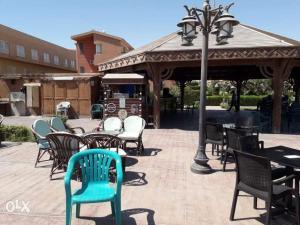 a group of chairs and tables and a gazebo at Marina Wadi Degla Villa Duplex 4 Bedrooms in Ain Sokhna