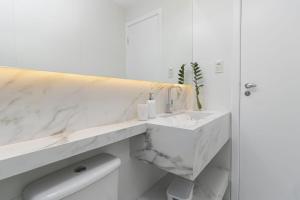 a white bathroom with a sink and a toilet at Casa belaju in Aracaju +61 photos