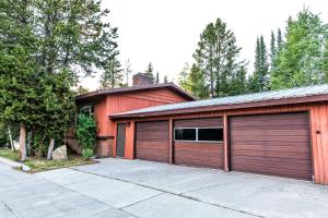 a red building with two garage doors on it at Geyser Getaway in West Yellowstone