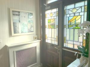 a room with a door and stained glass windows at La Villa Paris - B&B in Paris