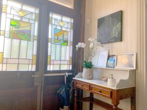 a room with a door with stained glass windows at La Villa Paris - B&B in Paris