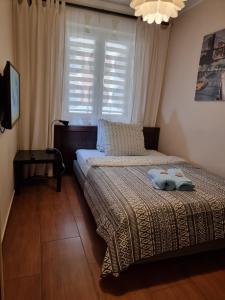 Posteľ alebo postele v izbe v ubytovaní Apartament Centrum Park