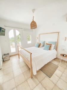 a bedroom with a large bed in a room with windows at Montgo Home in Jávea