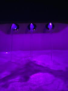 three purple lights in a room with purple lighting at Priory Farm Barn in Eye