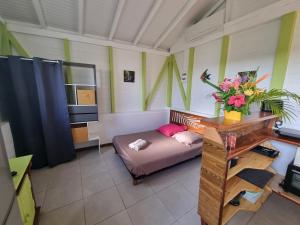 a living room with a couch and a table with flowers at Ti Pècheur in Sainte-Luce