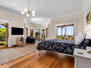 a bedroom with a bed and a living room at Tiverton in Kurrajong