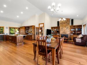 a large living room with a table and chairs at Tiverton in Kurrajong