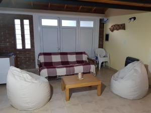 a living room with a couch and a table at Quinta El Descanso in Puerto Madryn