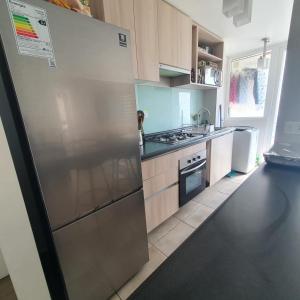 a kitchen with a large stainless steel refrigerator at DEPARTAMENTO EL OASIS in La Serena