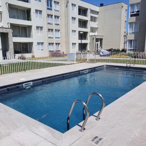a swimming pool in front of a apartment building at DEPARTAMENTO EL OASIS in La Serena