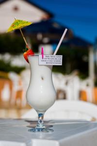 uma bebida com um morango e um guarda-chuva sobre uma mesa em Caxias Thermas Hotel em Piratuba