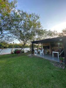a house with a table and chairs in a yard at Pousada Refúgio Náutico in Passo de Torres +23 photos